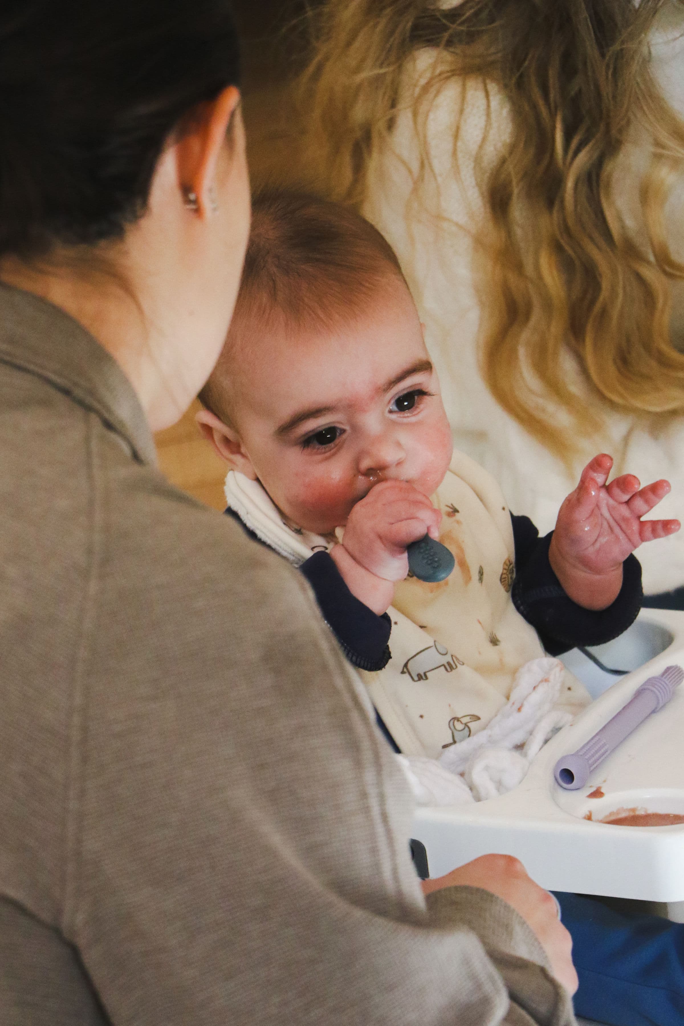 Baby experiencing real food during a starting solids session